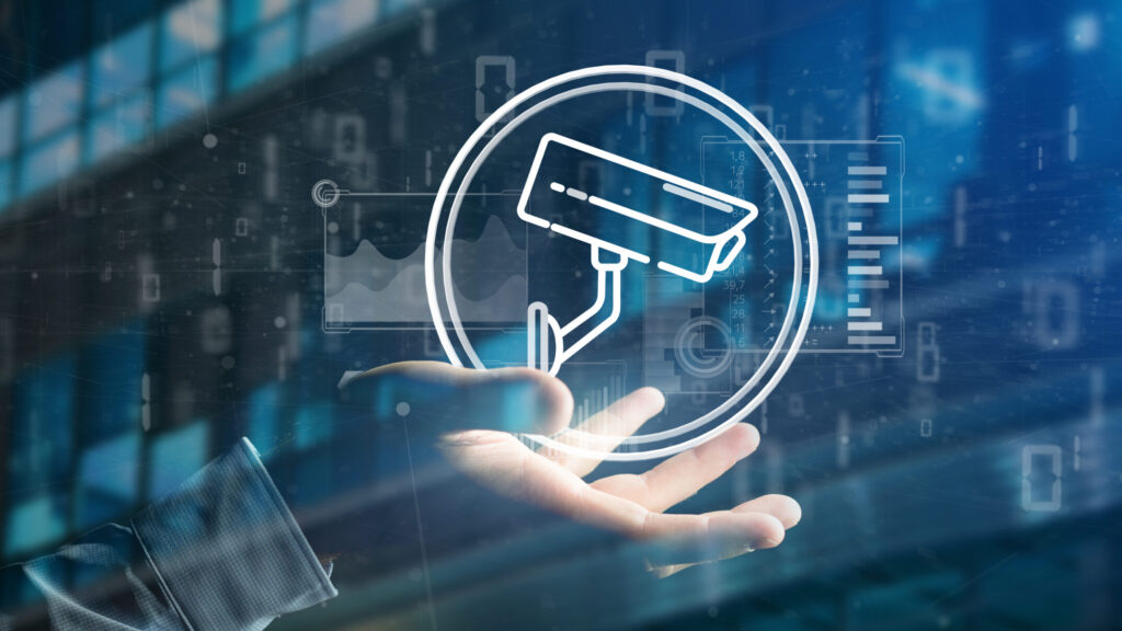 View of Businessman holding Security camera system icon and statistics data - 3d rendering