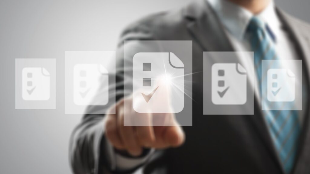 Businessman working on modern virtual screen, paperwork with checkbox lists,